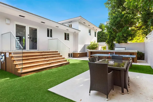 an aerial view of a house with garden space and street view
