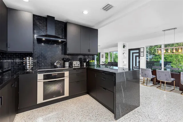 a kitchen with stainless steel appliances granite countertop a stove sink and cabinets