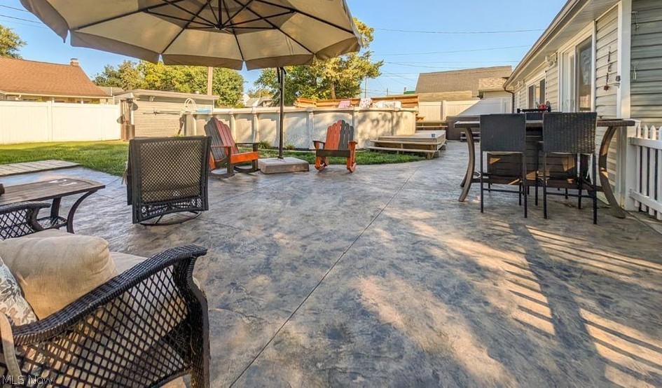 41 Poplar Street Huron, OH 44839 - Photo 27 of 37 Fenced backyard featuring a patio area and outdoor dining space