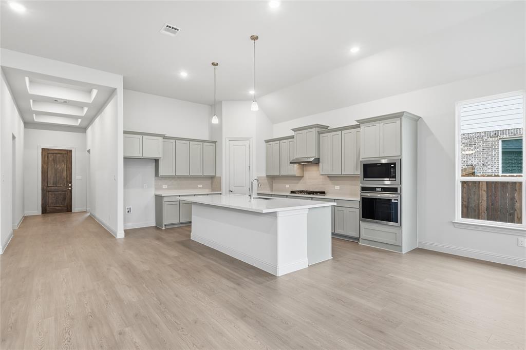 556 Flint Road Waxahachie, TX 75167 - Photo 20 of 39 a kitchen with white cabinets and window
