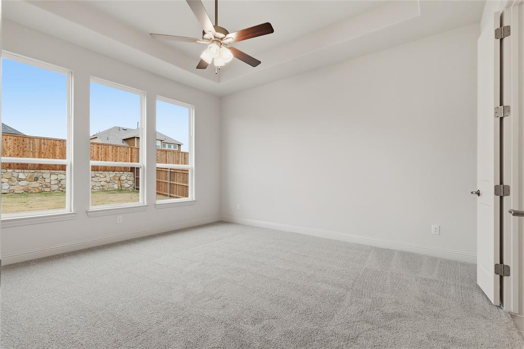 556 Flint Road Waxahachie, TX 75167 - Photo 23 of 39 an empty room with chandelier fan and windows