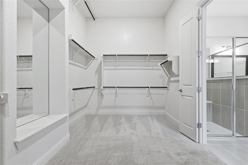 556 Flint Road Waxahachie, TX 75167 - Photo 32 of 39 a bathroom with a glass shower door and a bathtub