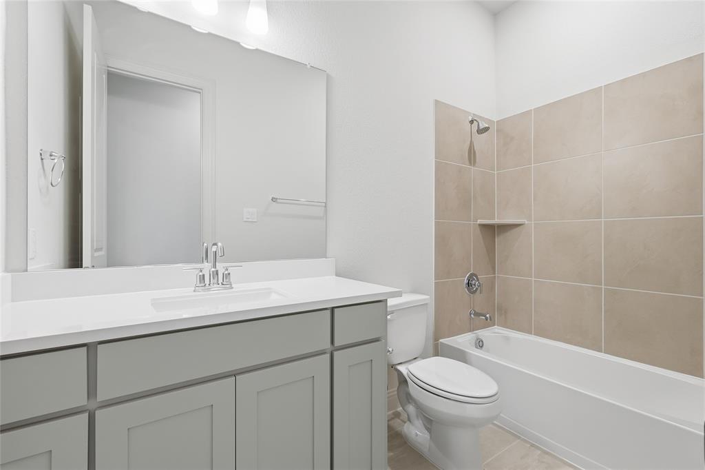 556 Flint Road Waxahachie, TX 75167 - Photo 6 of 39 a bathroom with a sink a toilet and shower