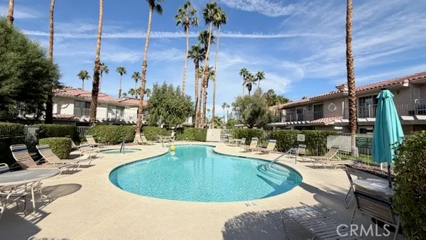 a view of a swimming pool with outdoor seating