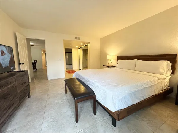 a bedroom with a bed and a couch