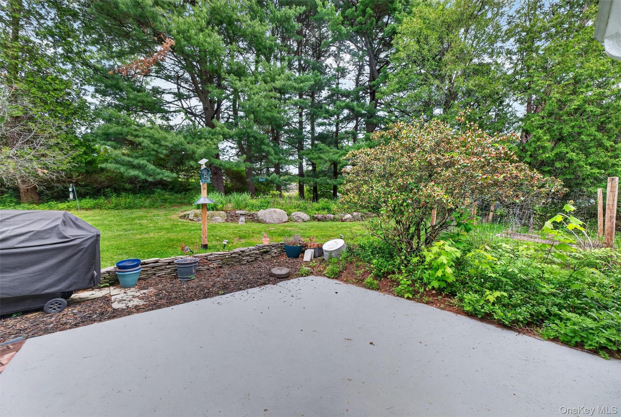 10 Edwin Road Poughkeepsie, NY 12603 - Photo 39 of 46 a view of a garden with a bench and trees