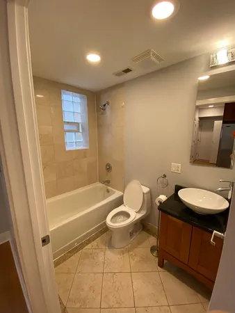 a bathroom with a sink a toilet and bathtub