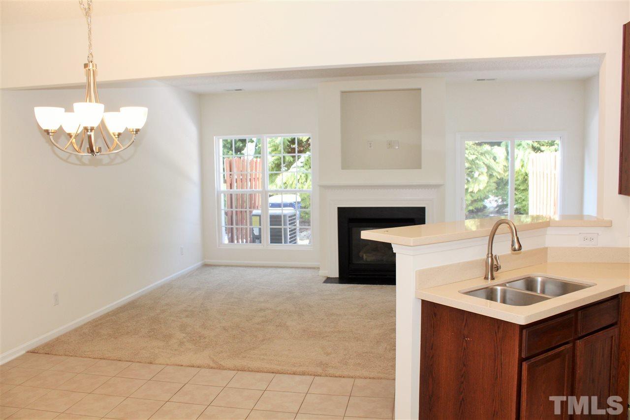 3043 Settle In Lane Raleigh, NC 27614 - Photo 2 of 19 a kitchen with a sink chandelier and fireplace