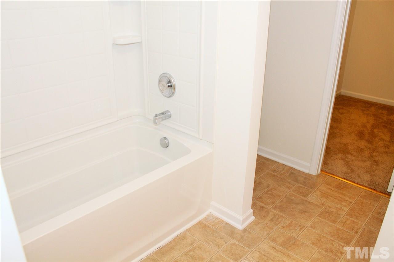 3043 Settle In Lane Raleigh, NC 27614 - Photo 13 of 19 a white bath tub sitting next to a white sink