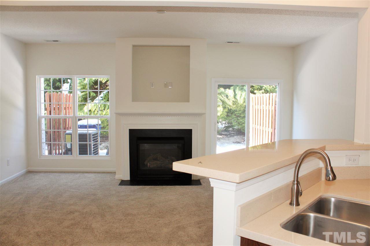 3043 Settle In Lane Raleigh, NC 27614 - Photo 3 of 19 a living room with a fireplace and a large window