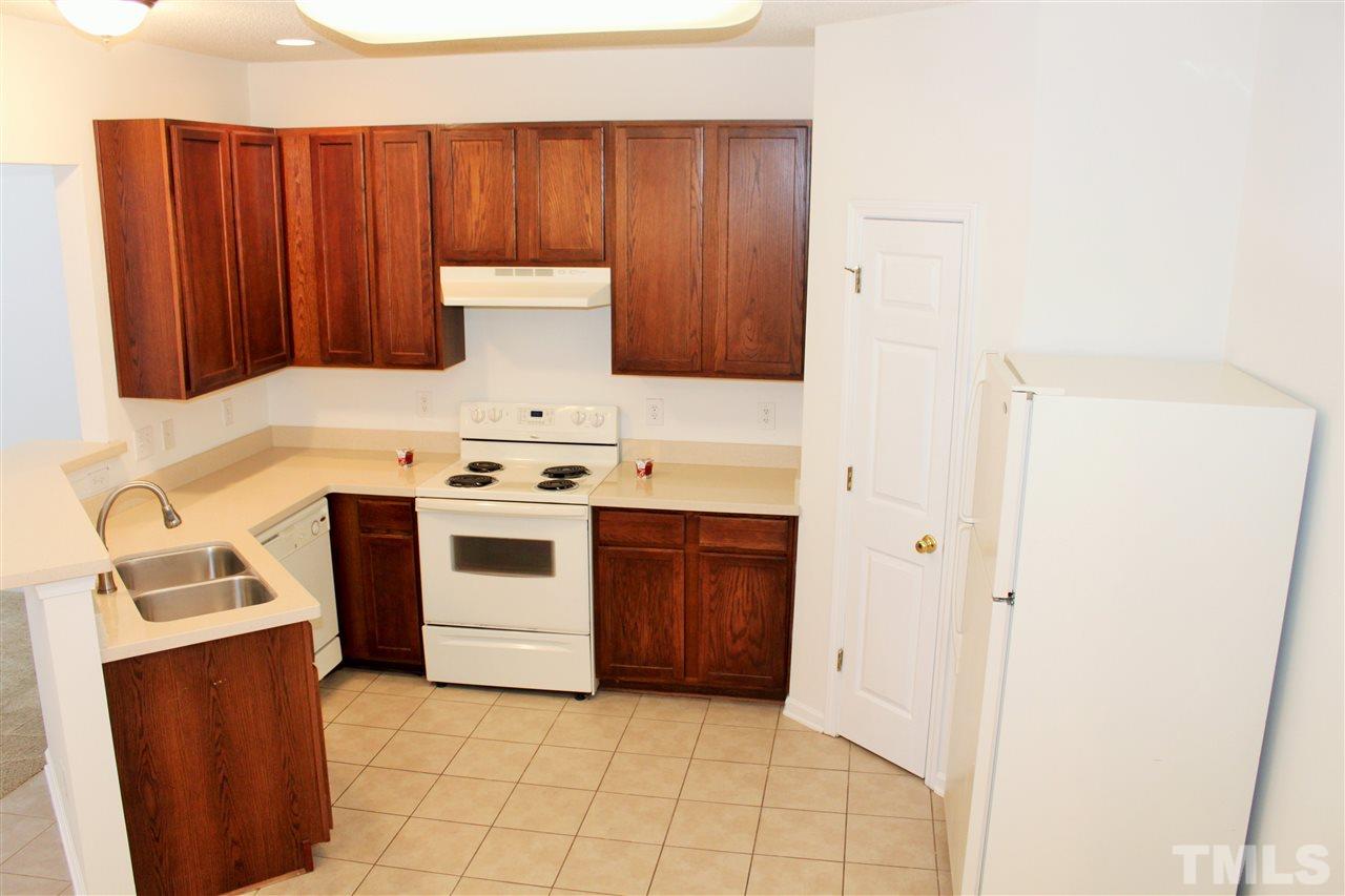 3043 Settle In Lane Raleigh, NC 27614 - Photo 5 of 19 a white stove top oven sitting inside of a kitchen