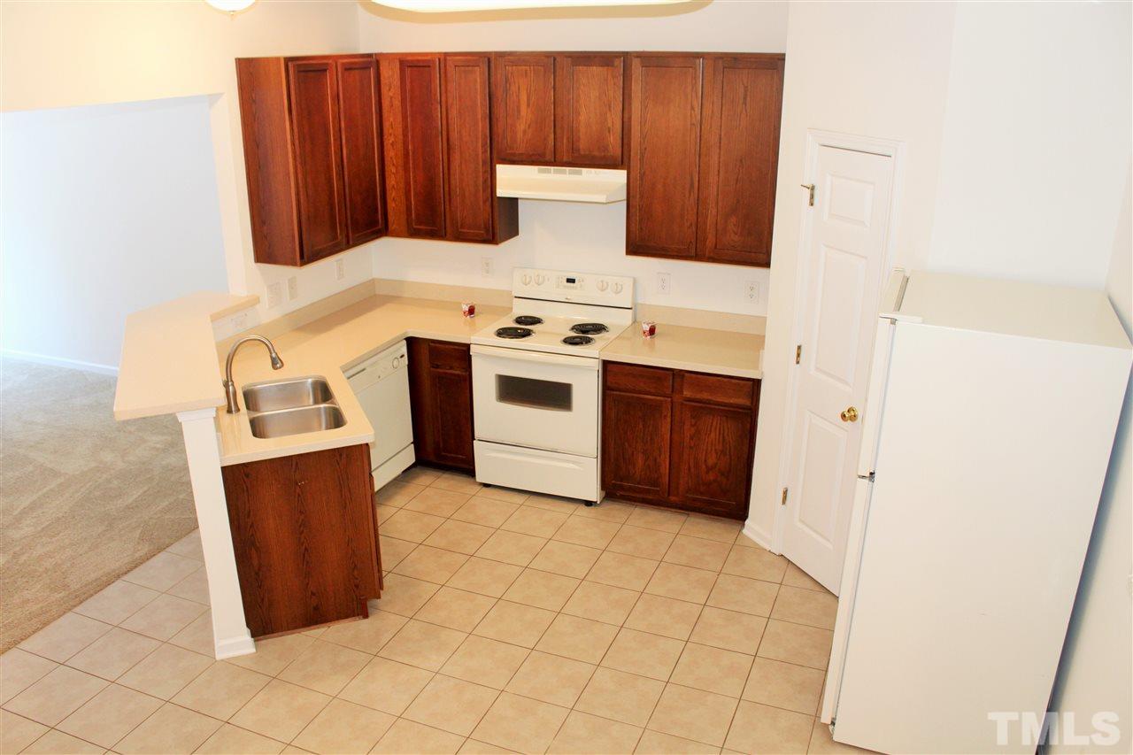3043 Settle In Lane Raleigh, NC 27614 - Photo 6 of 19 a kitchen with stainless steel appliances a stove a refrigerator and cabinets
