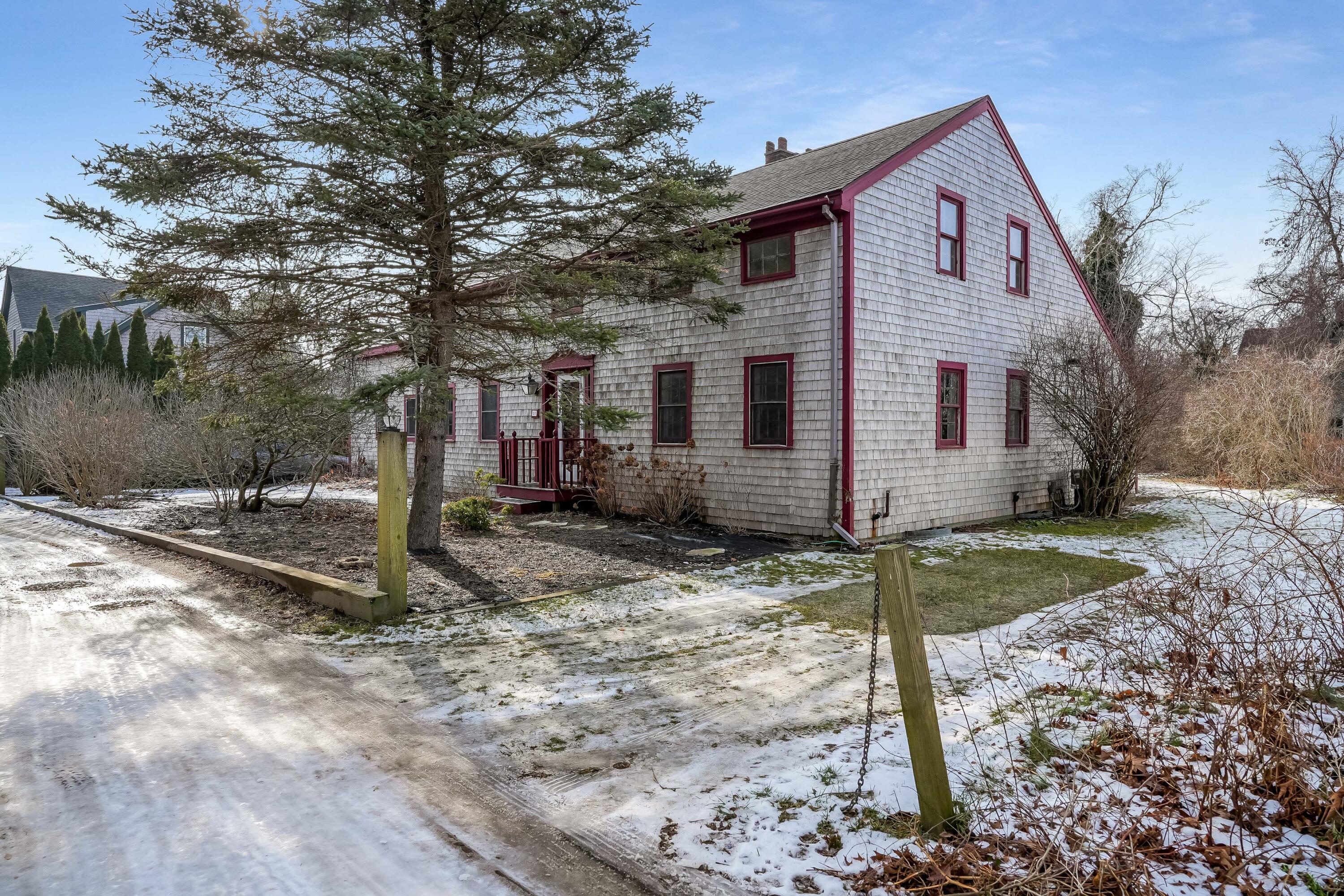 32 Norton Orchard Road Edgartown, MA 02539 - Photo 3 of 26 a front view of a house with a yard