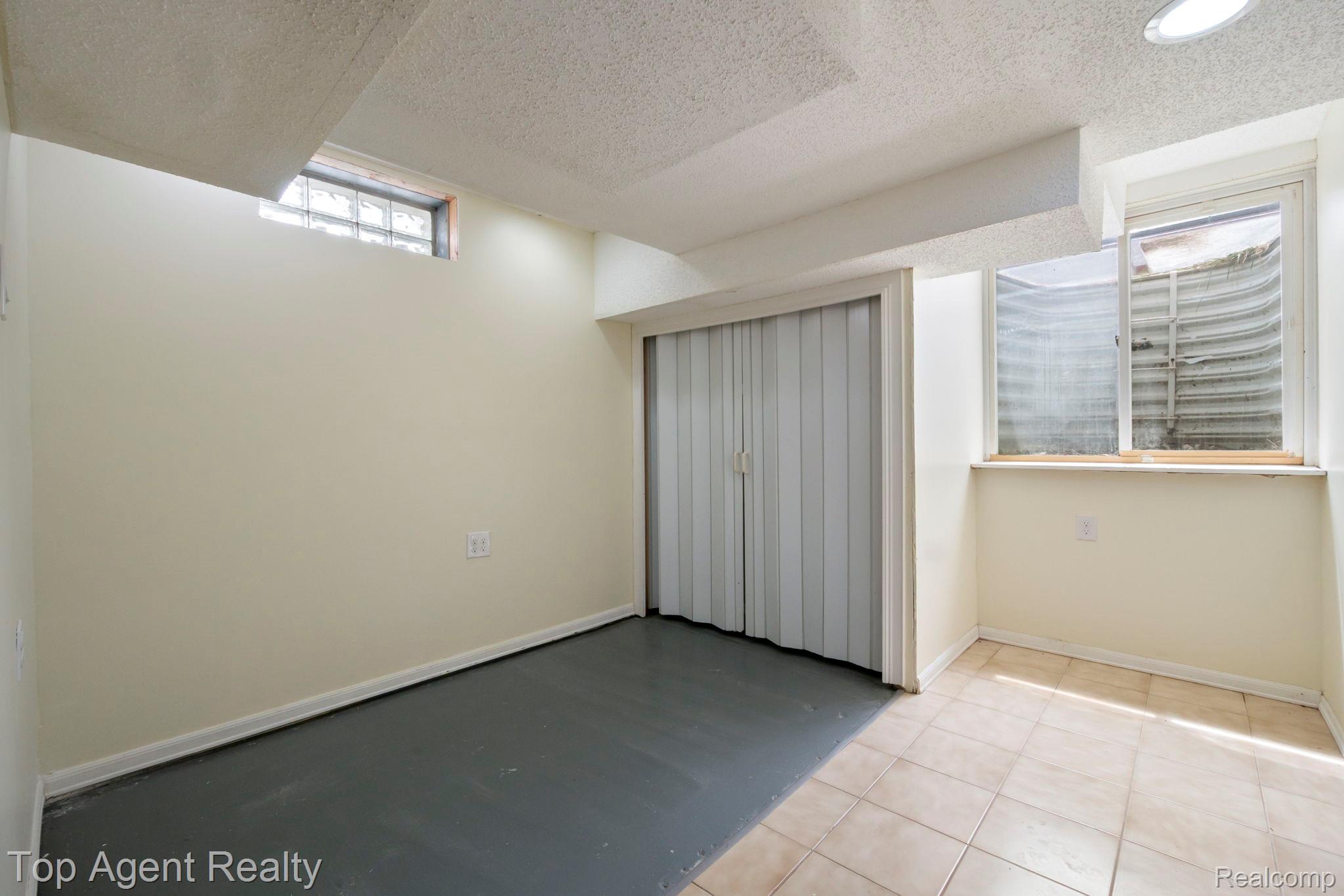 2018 John R Road Troy, MI 48083 - Photo 22 of 30 Unfurnished bedroom with a textured ceiling and baseboards