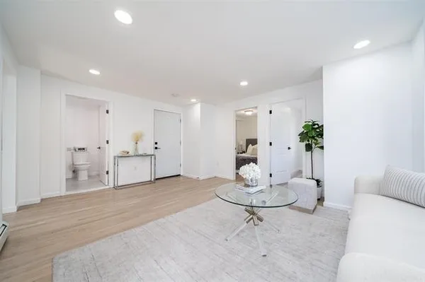 a living room with kitchen island furniture and white kitchen