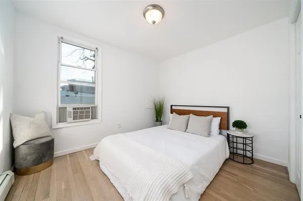 a bedroom with a bed and a window