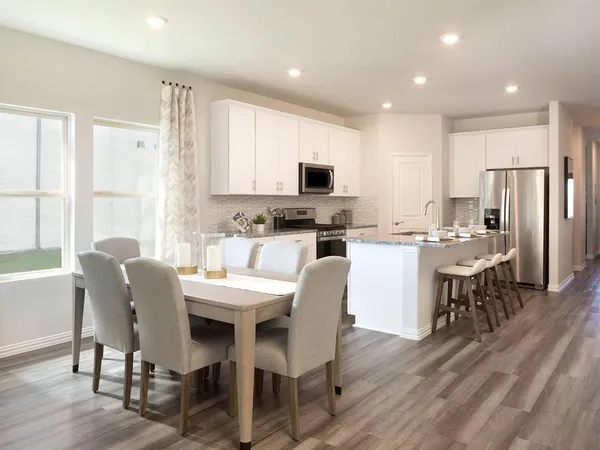 a kitchen with kitchen island wooden cabinets and stainless steel appliances