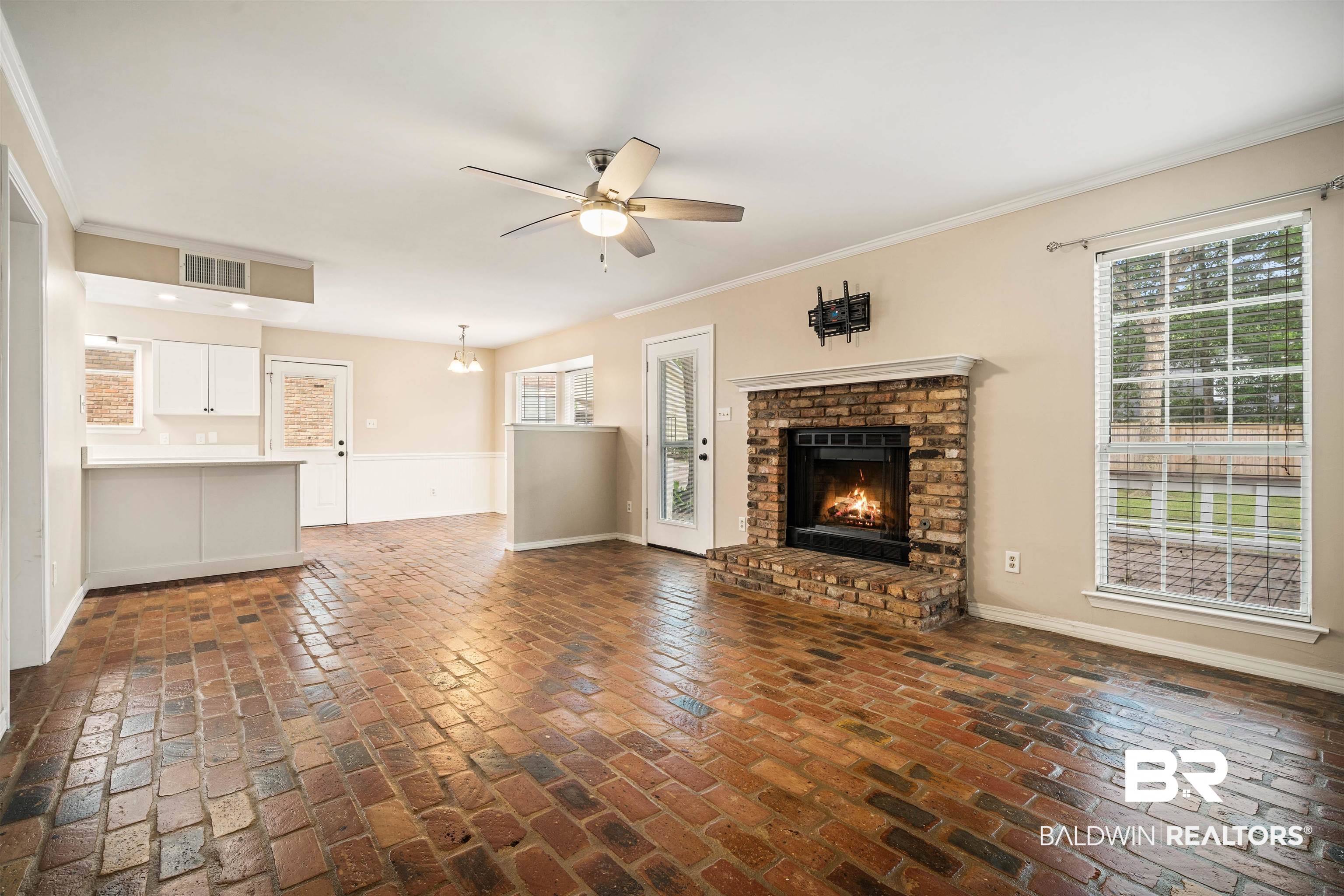 804 Wildwood Avenue Mobile, AL 36609 - Photo 6 of 30 Unfurnished living room with crown molding, a brick fireplace, and ceiling fan