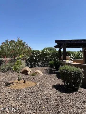 a view of a patio with table and chairs potted plants