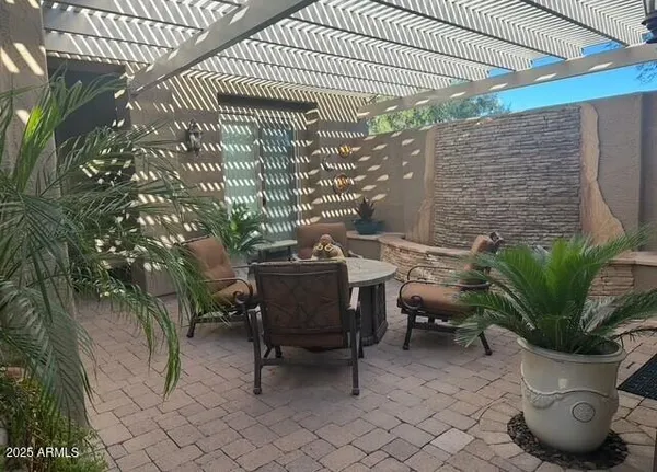 a view of a chairs and table in a patio