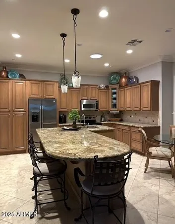 a large kitchen with a table and chairs