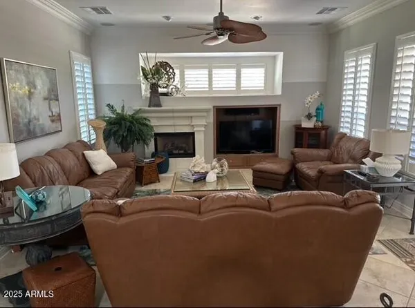 a living room with furniture a fireplace and a window