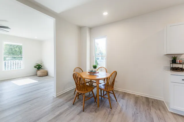 a view of a dining room with furniture and wooden floor
