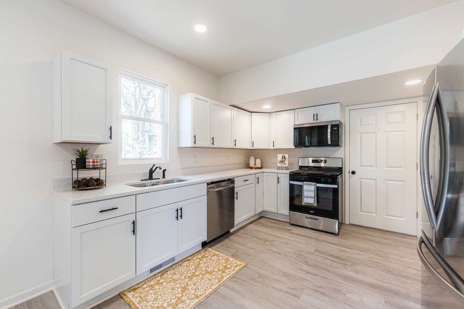 615 Prospect Street DeKalb, IL 60115 - Photo 13 of 27 a kitchen with granite countertop white cabinets and stainless steel appliances
