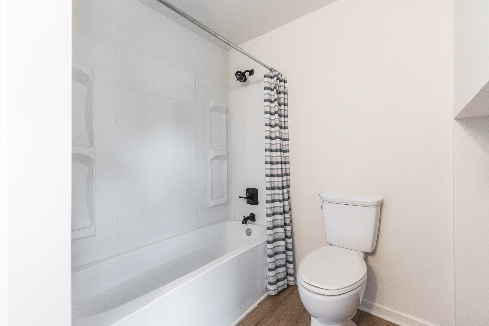 615 Prospect Street DeKalb, IL 60115 - Photo 22 of 27 a white toilet sitting next to a bathtub