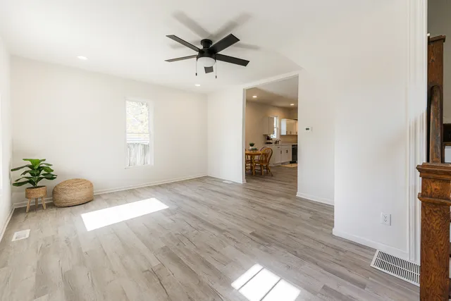 a view of an empty room and wooden floor