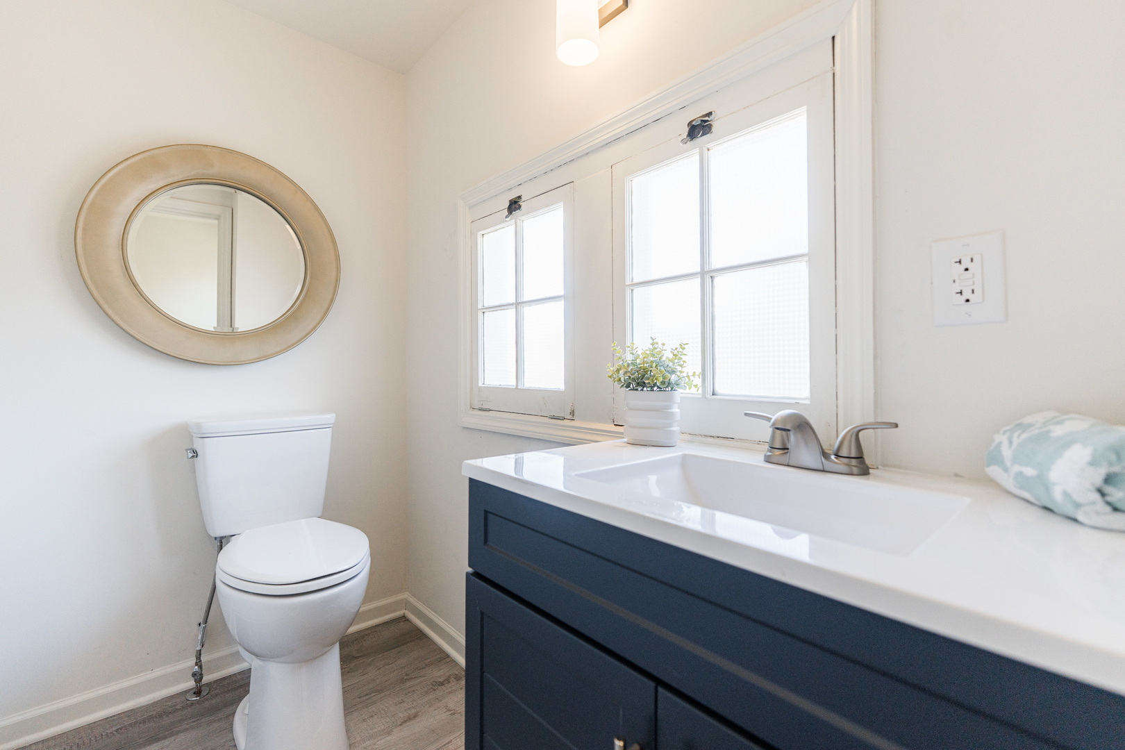 615 Prospect Street DeKalb, IL 60115 - Photo 10 of 27 a bathroom with a toilet a sink and a mirror