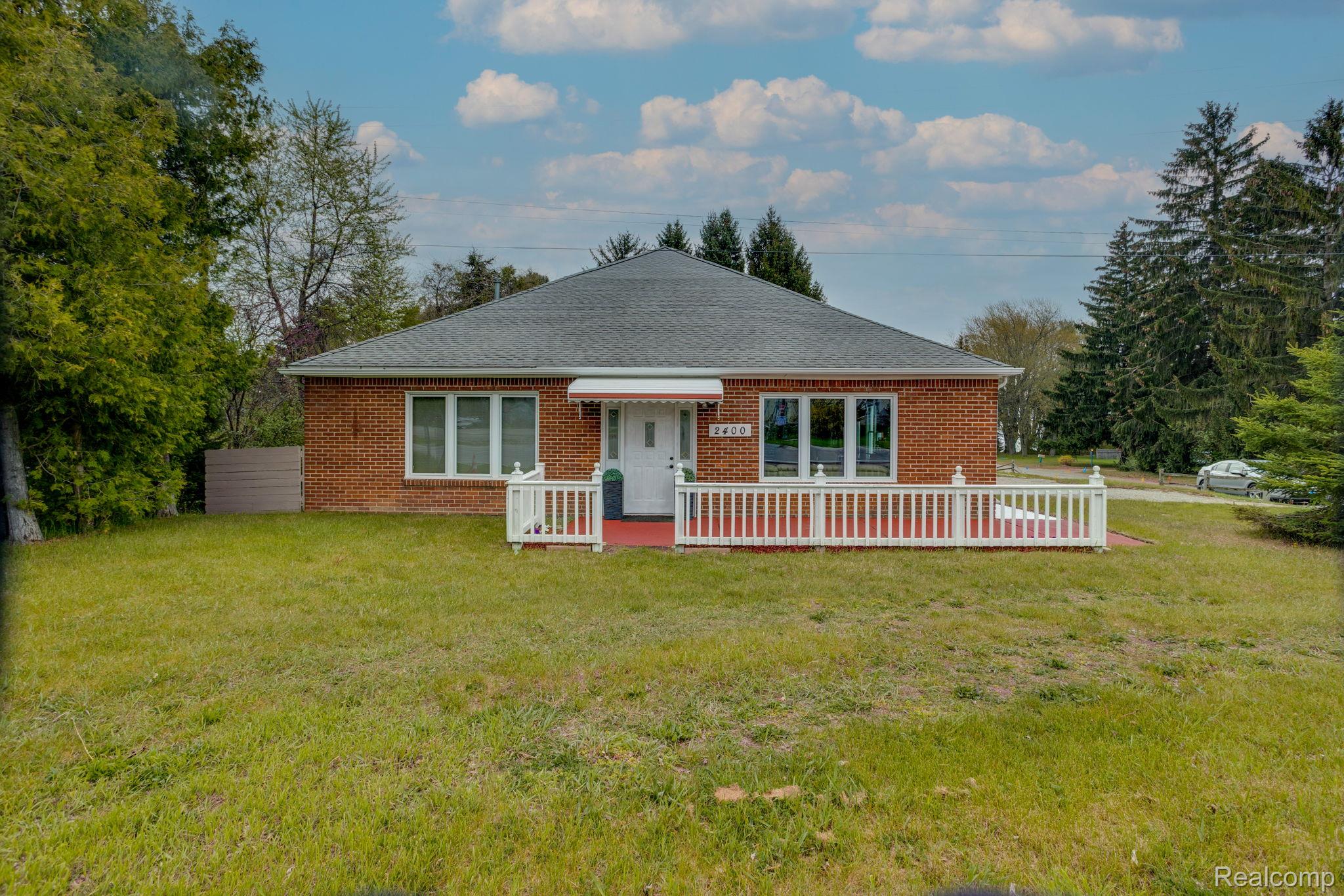2400 North Lakeshore Road Carsonville, MI 48419 - Photo 1 of 33 Ranch-style house featuring a front lawn, brick siding, and a shingled roof