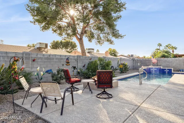 a view of backyard with outdoor seating and plants