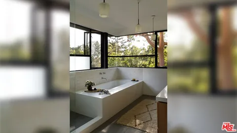 a bathroom with a bathtub and a window