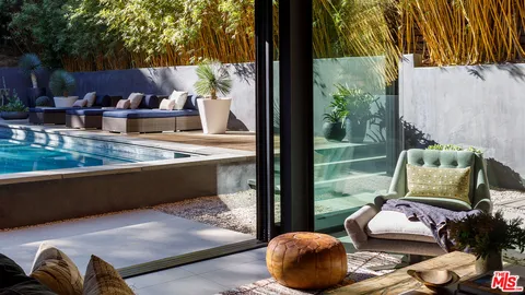 a living room with furniture and a floor to ceiling window