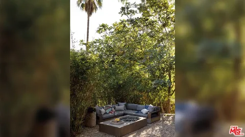 a view of a yard with plants and a patio
