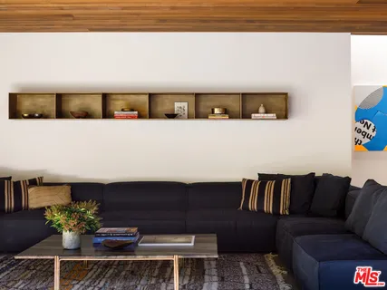 a living room with furniture and flowers