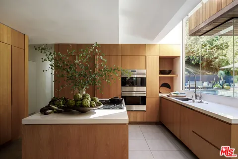 a kitchen with a sink stove and refrigerator