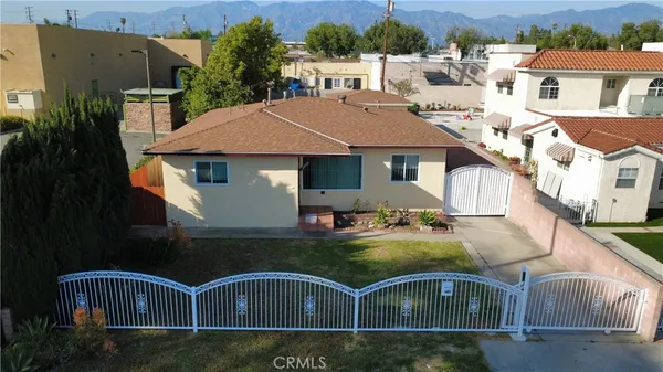 an aerial view of a house with swimming pool garden and patio