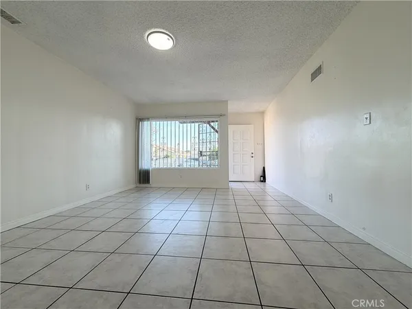 a kitchen with white cabinets a sink and a window