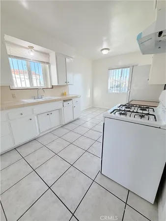 a kitchen with a stove top oven sink and cabinets