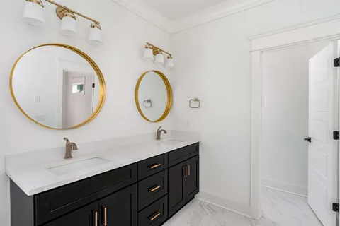 a bathroom with a double vanity sink and a mirror