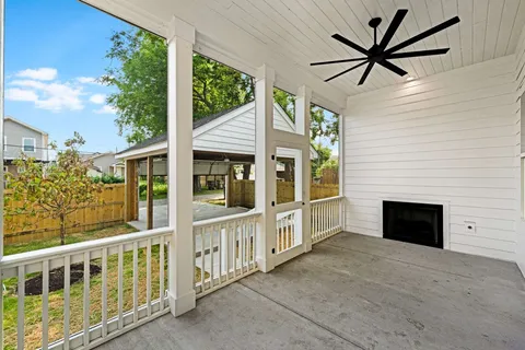 a view of a porch with a table and chairs