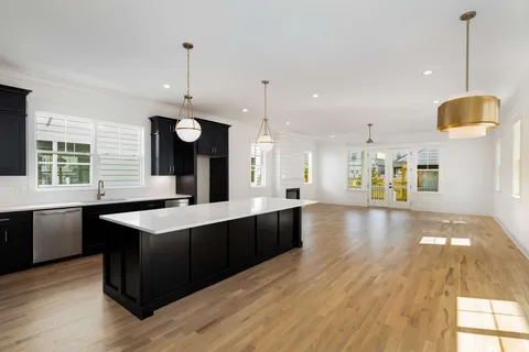 a large kitchen with lots of counter space and wooden floor