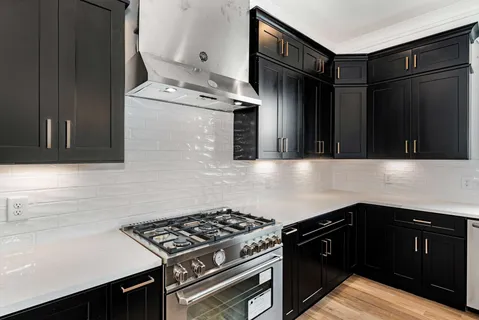 a kitchen with granite countertop a stove and a refrigerator