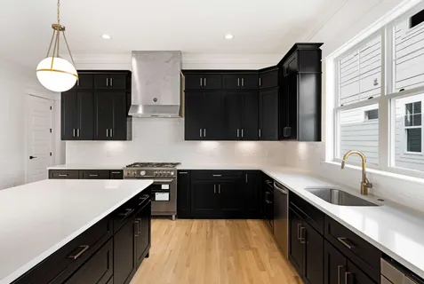 a kitchen with a sink a stove and cabinets
