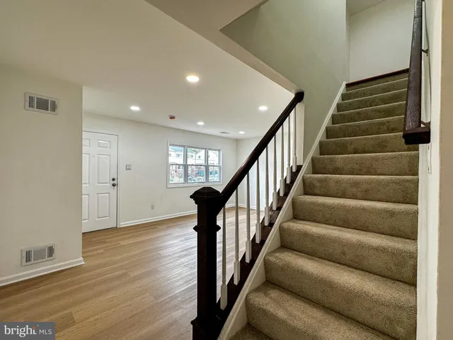 a view of entryway and hall with wooden floor