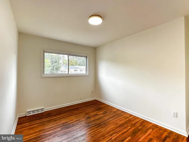 a view of a room with wooden floor and fan