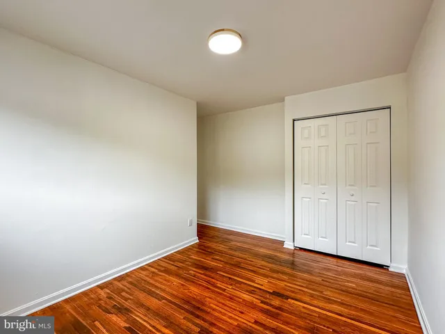 a view of an empty room and wooden floor