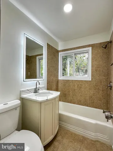 a bathroom with a sink toilet and tub